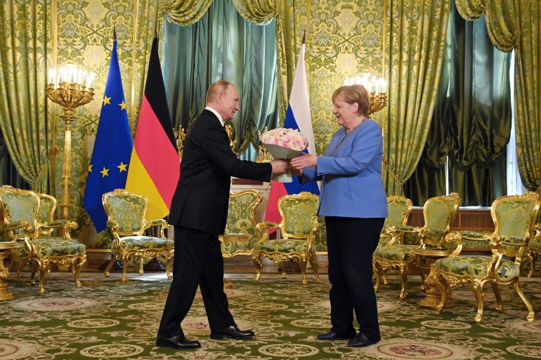Putin Greets Angela Merkel
