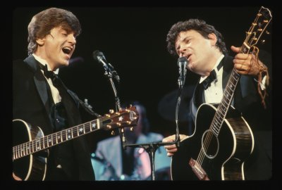 The Everly Brothers performing on stage.