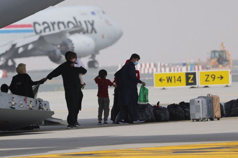 Evacuees from Afghanistan disembark a plane.