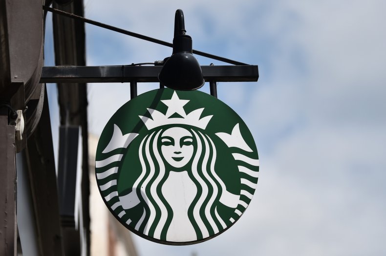 Starbucks sign hangs outside coffee shop