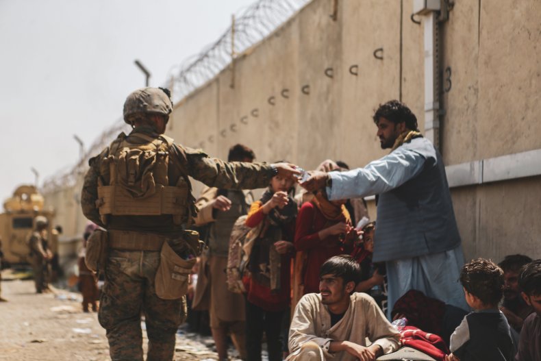 U.S. Marines handing water to Afghan evacuees.