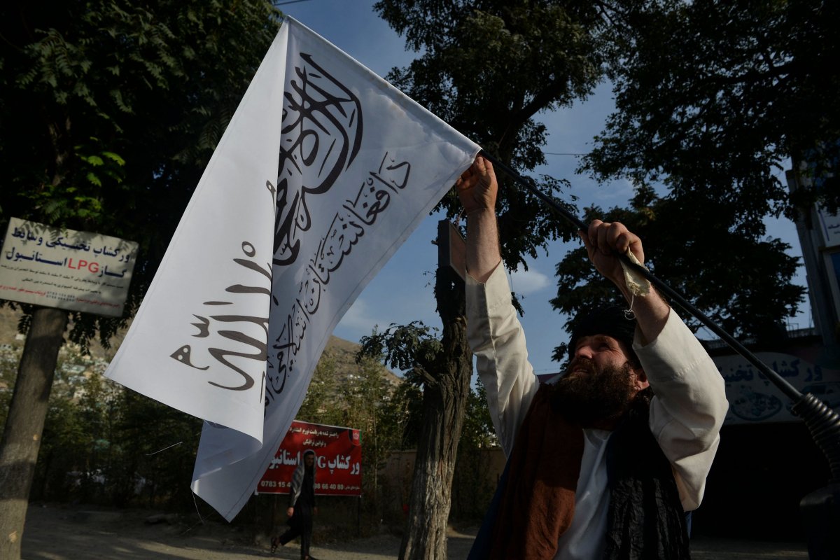Man with Taliban flags in Kabul, Afghanistan