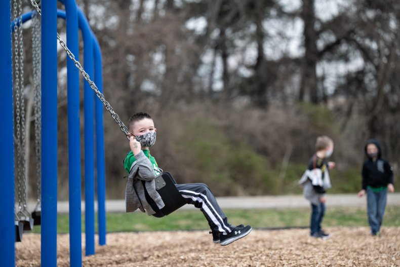 A child uses a swingset