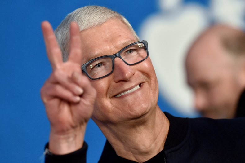 Apple's Tim Cook making a peace sign.
