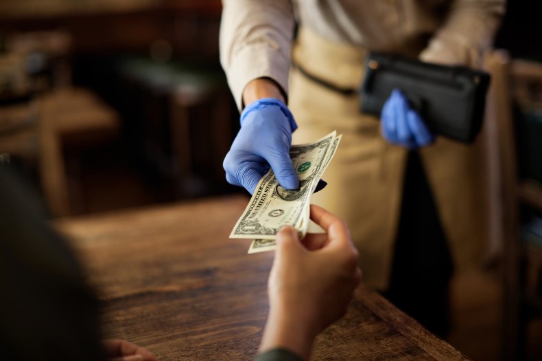 Waiter handling money in restaurant