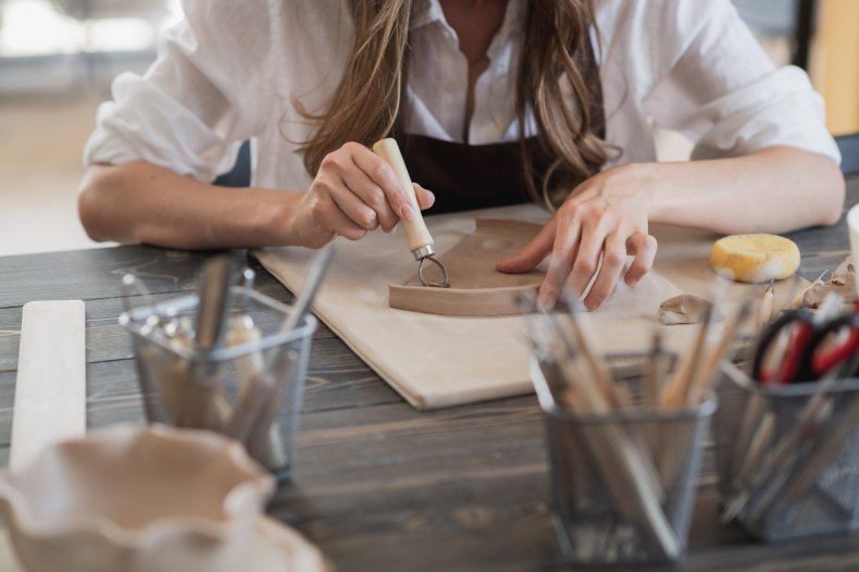Artist working with clay in studio
