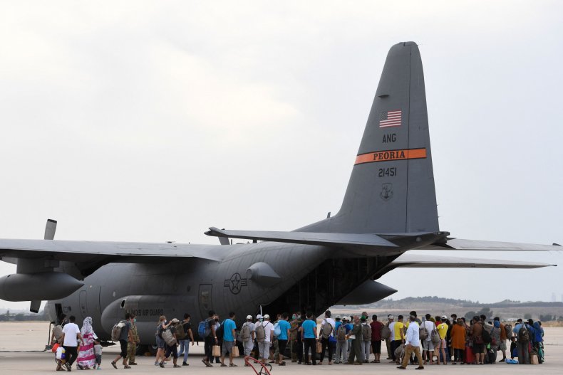 Refugees board aircraft