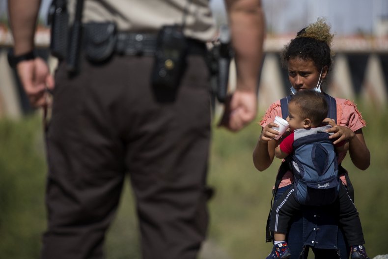 Migrant Child Holding a Baby