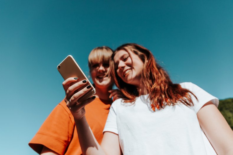 Teenage girls look at smartphone