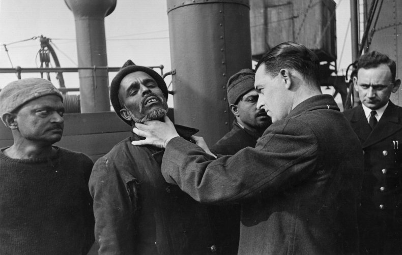 A doctor examining a man for typhus.