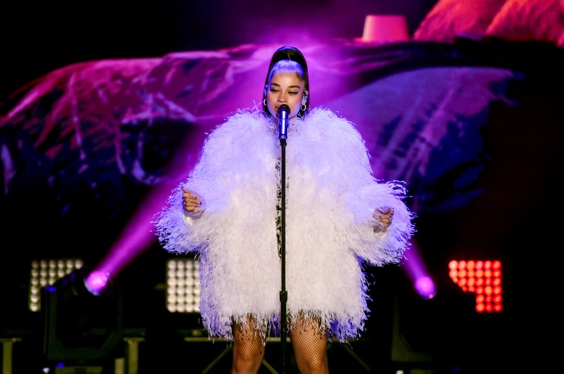 Ella Mai performs in a white dress