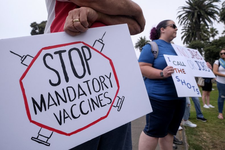 An Anti-Vaccination Protestor Holds a Sign
