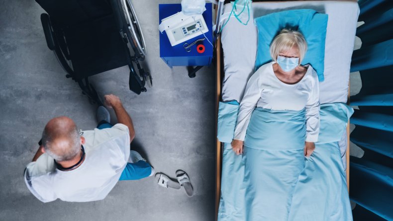 A woman in a hospital bed.