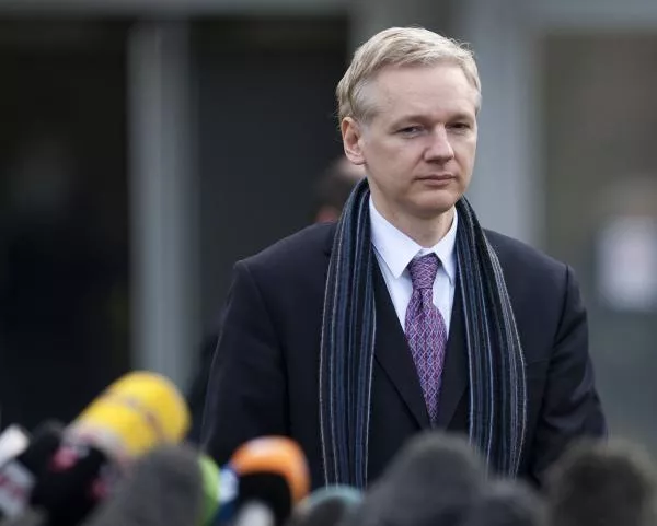 WikiLeaks founder Julian Assange approaches microphones