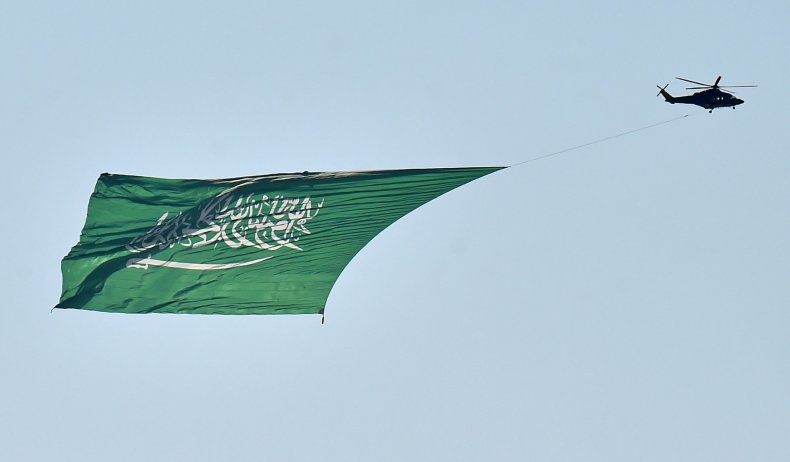 Saudi military helicopter, carrying a huge flag