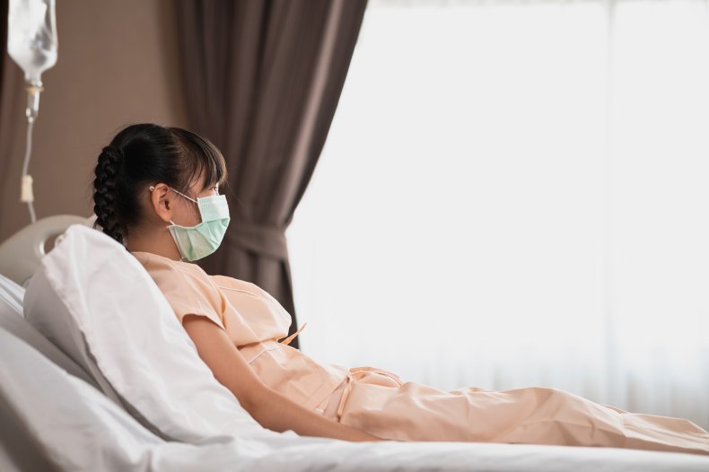 A girl wearing a facemask in hospital