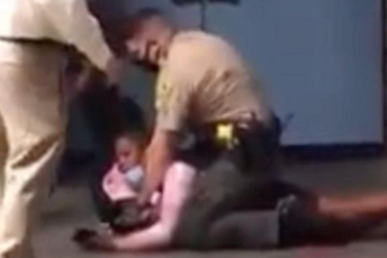 Black student pinned down by officeer