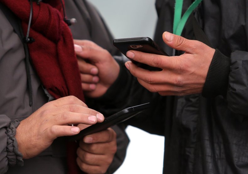 People hold smartphones in their hands