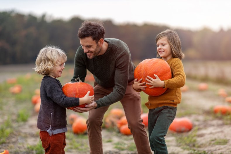 Family picks pumpkin at patch