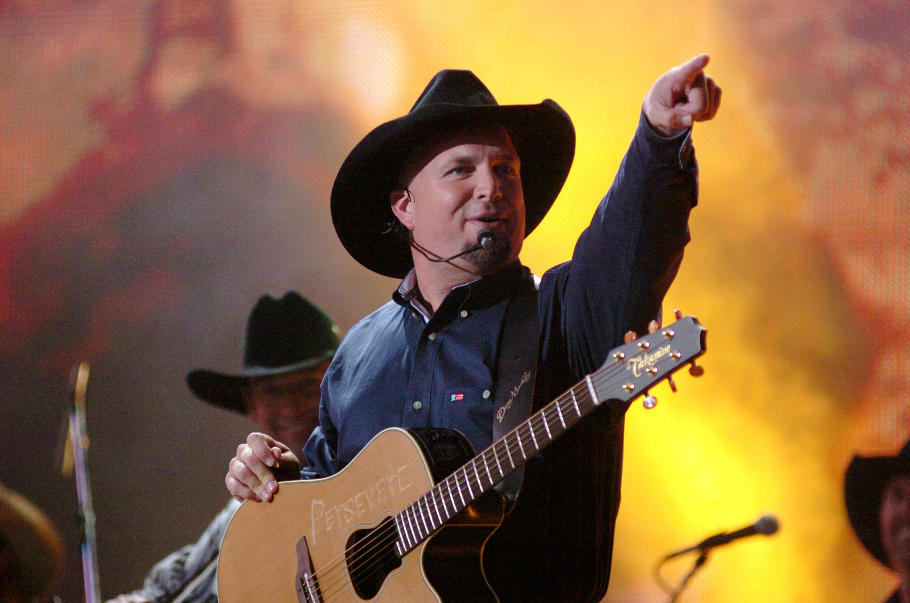 Garth Brooks cancels stadiums for dive bars over vaccine concerns.
