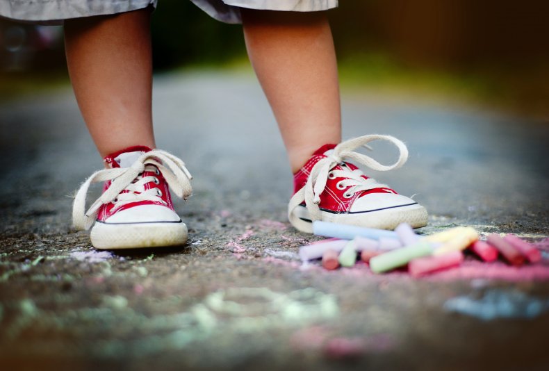 Toddler standing in front of chalk