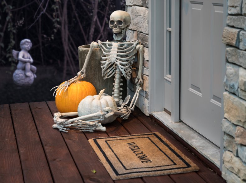 A Halloween skeleton on a doorstep.