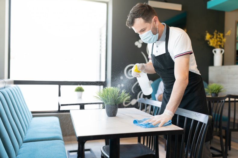 Waiter cleaning a table