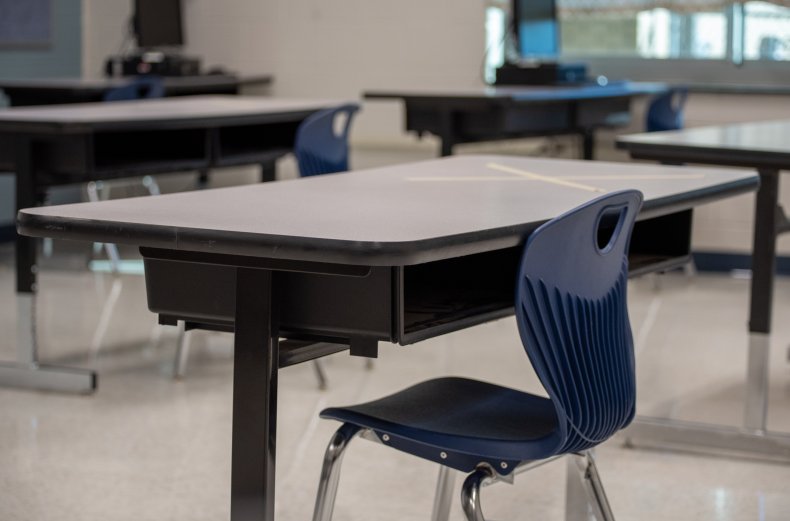 An empty chair in a school classroom