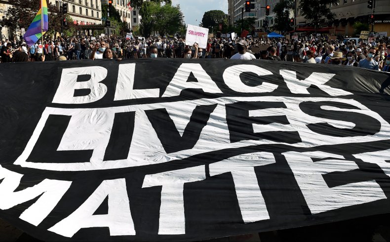 Demonstrators deploy a "Black Lives Matter" banner 