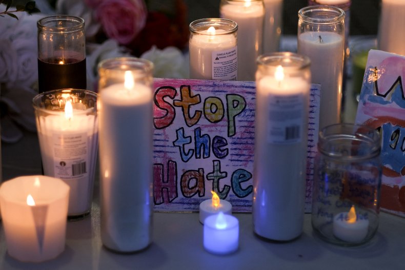 An anti-hate sign and candles