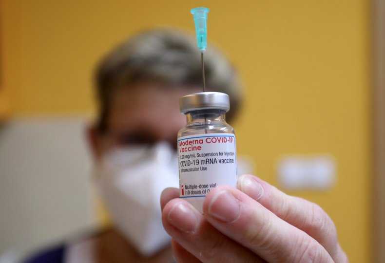 Moderna vaccine vial held to camera