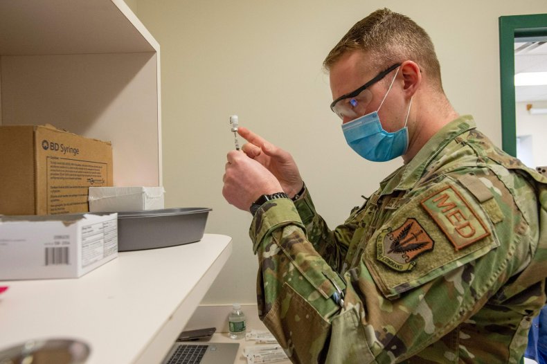 US Air Force Airman reconstitutes the vaccine