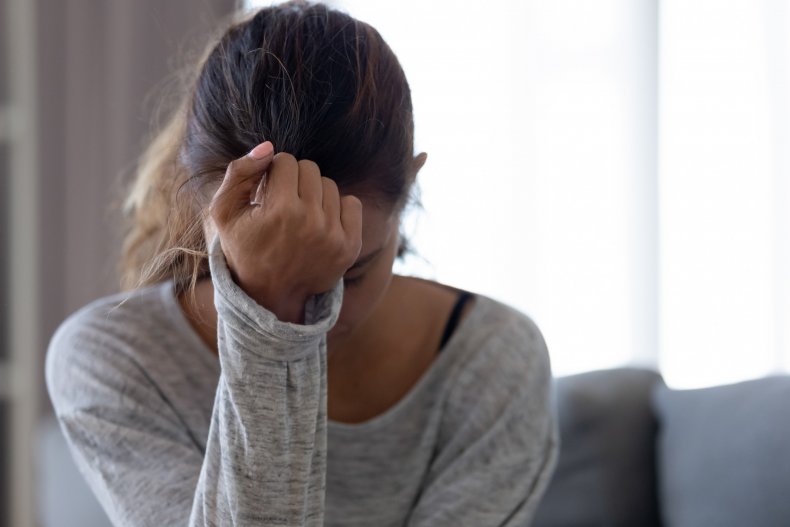 Anxious woman with her head in hands