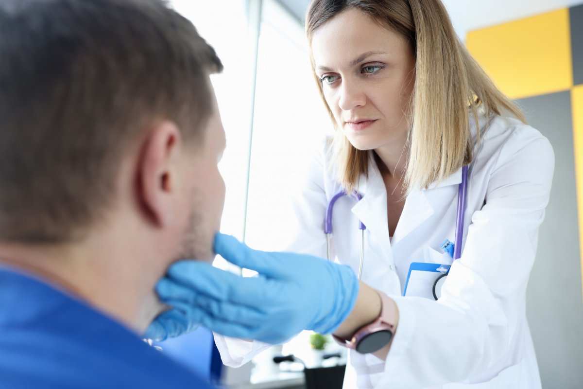 Doctor examines patient's lymph nodes