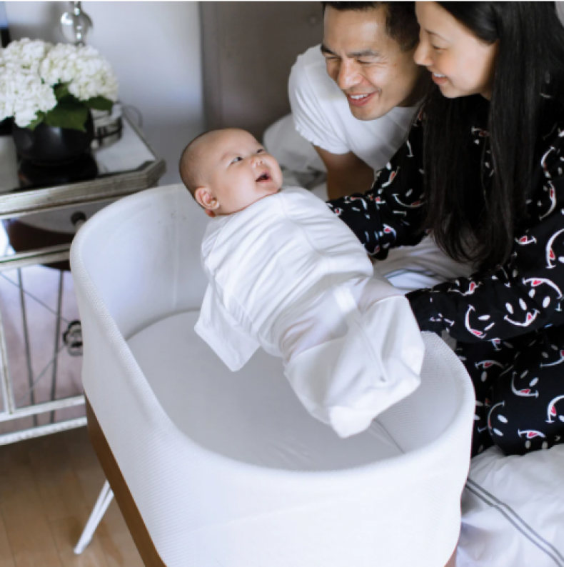 Parents place their baby in the Snoo