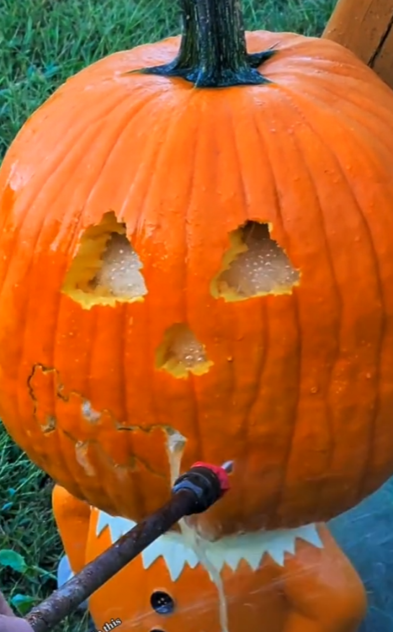Carved pumpkin with a power washer