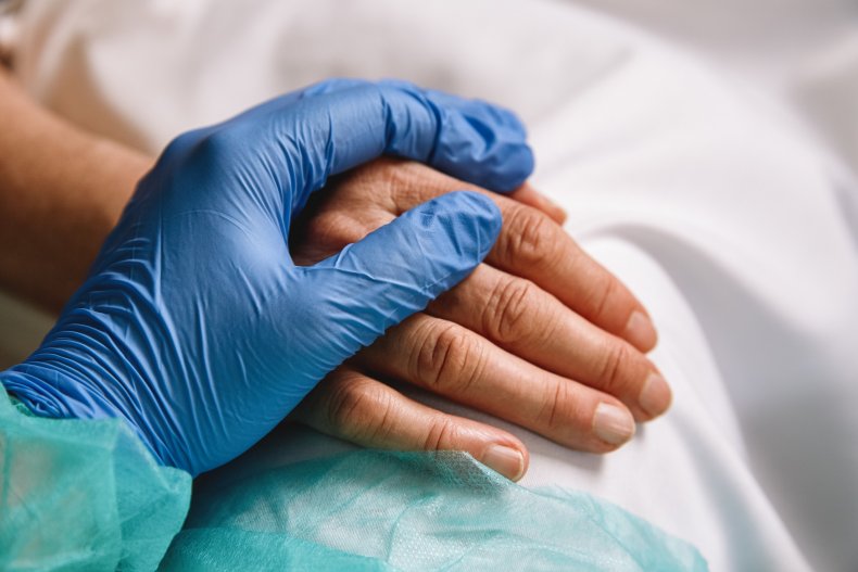 nurse holding patient's hand