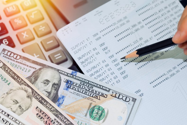 Dollars and bank account book on table.