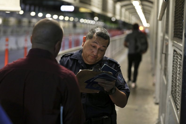 Border Officer Checks Migrant Documents
