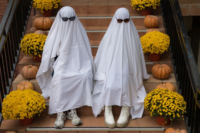 Two people dressed as ghosts
