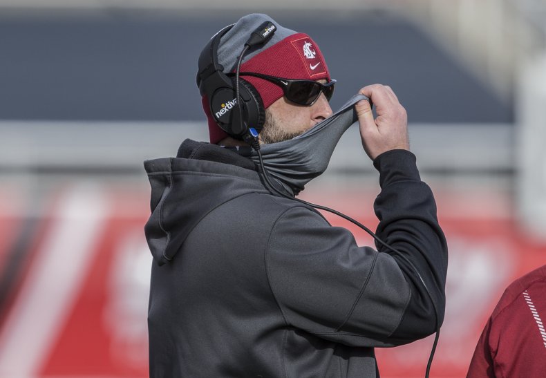 Nick Rolovich adjusts his mask
