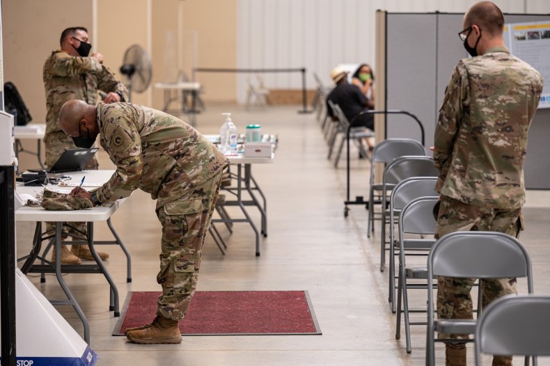 Soldiers file paperwork before getting COVID vaccine