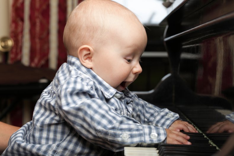A baby playing the piano.