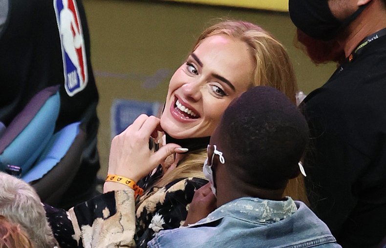 Adele smiles at an NBA game