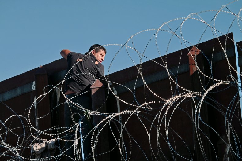 Immigrant scales border wall