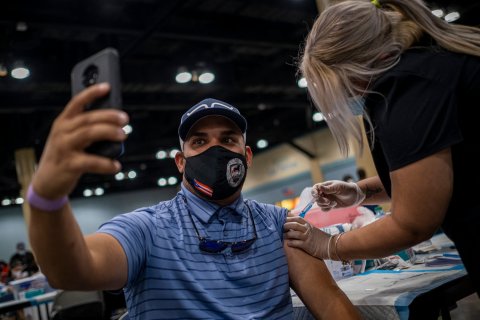 A man takes selfie after getting vaccine