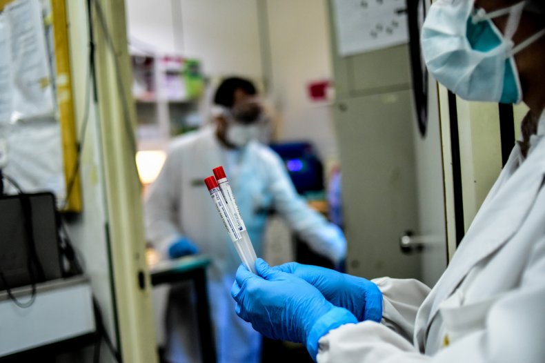 Lab worker with COVID test samples