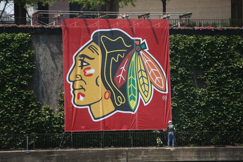 A Worker Adjusts a Chicago Blackhawks Banner