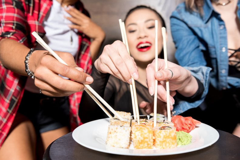 File photo of women eating sushi.