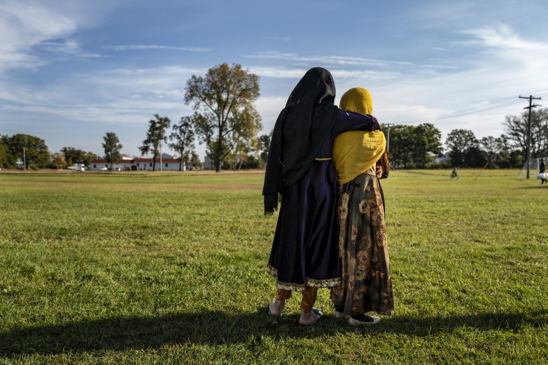 Afghan refugee girls watch a soccer match 